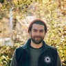 Rob Bullen Marketing Manager at CAT wearing a red woollen hat and green jumper