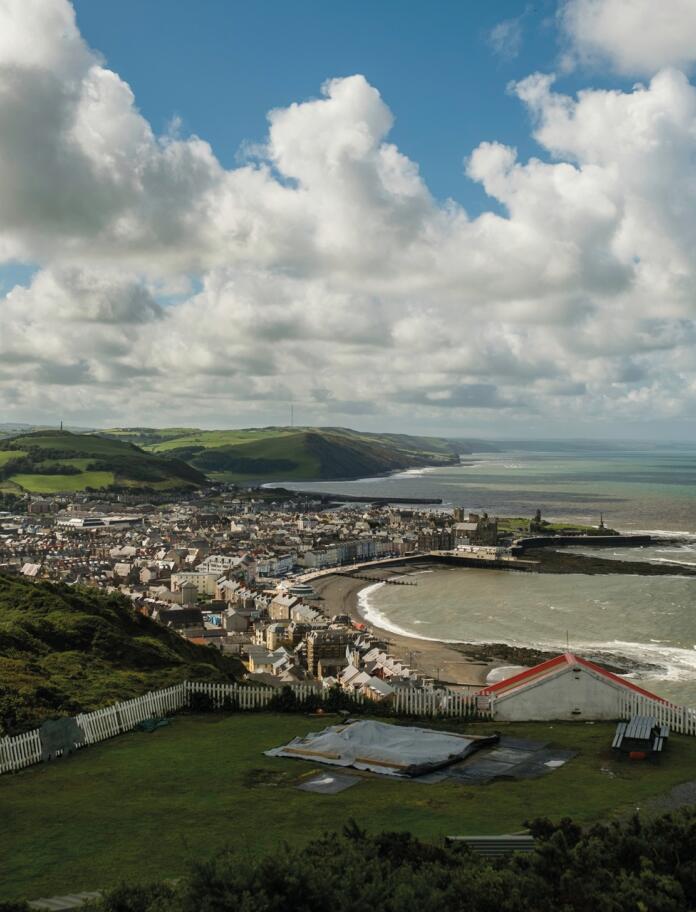 coastal town and sea viewed from hill.